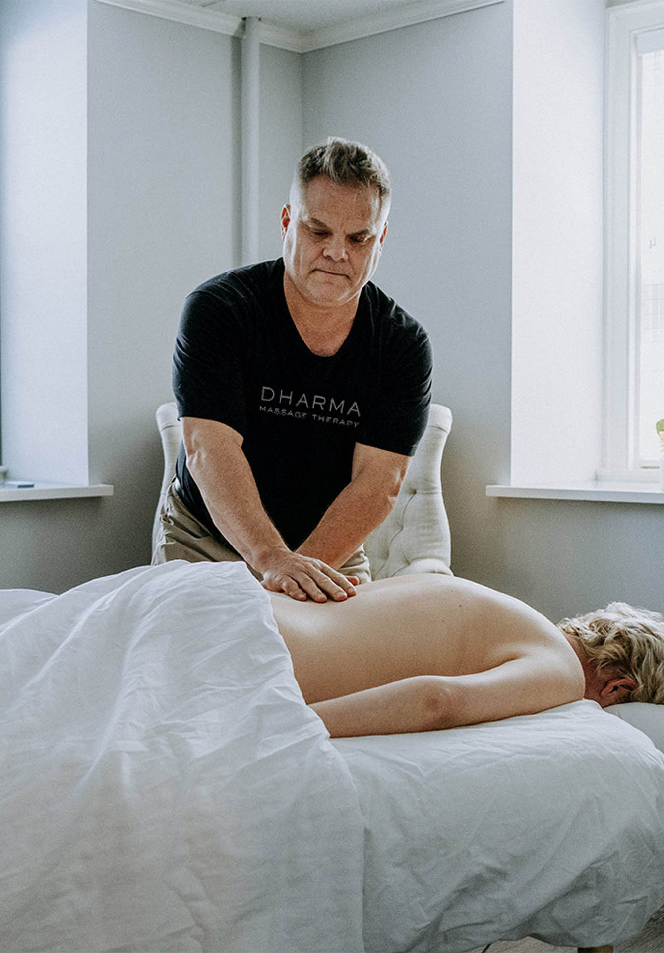 Massage therapist Mark massaging a woman on a table